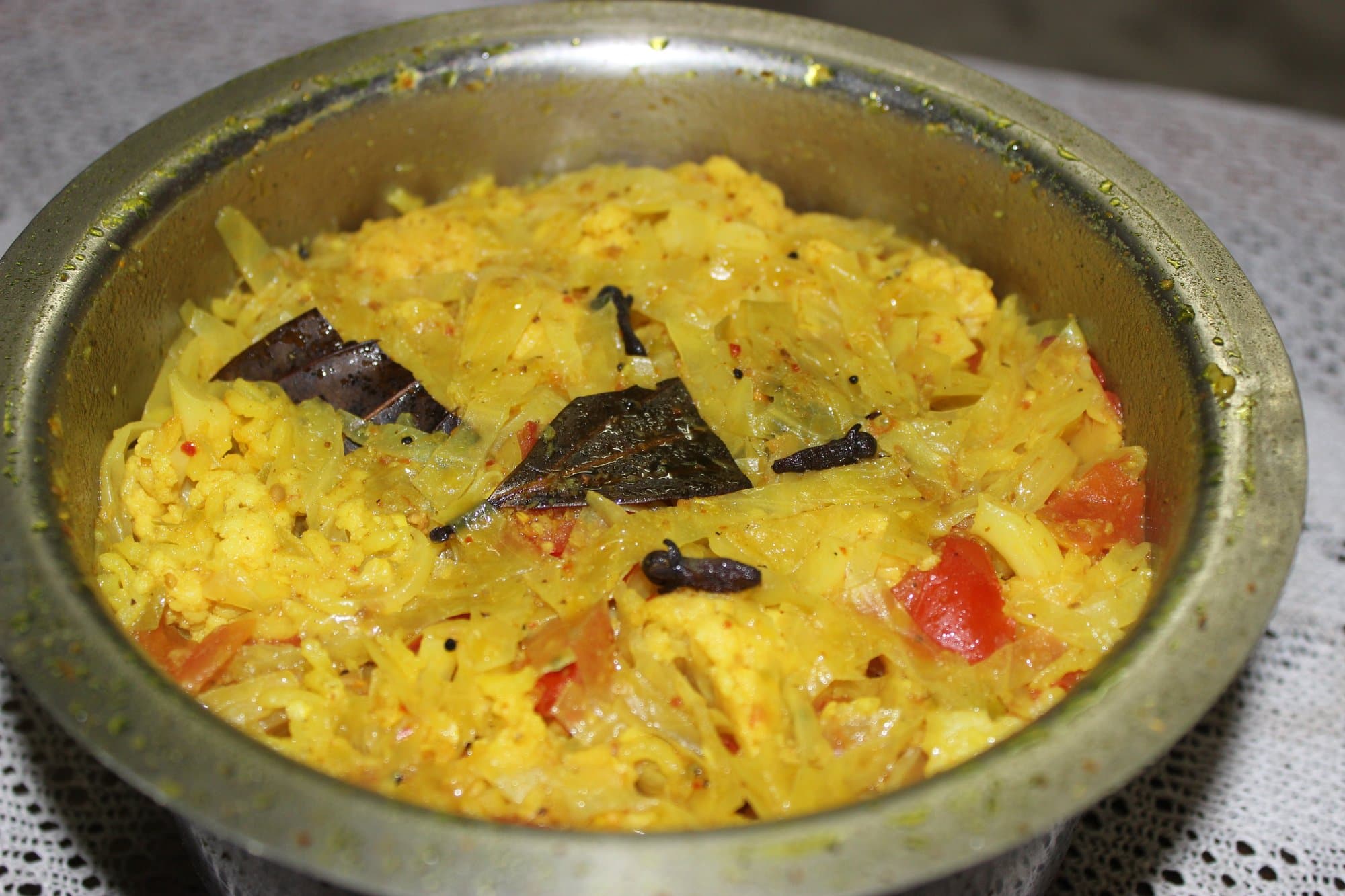 Masala khichdi in a steel bowl: soft rice and lentils with green chilli and coriander
