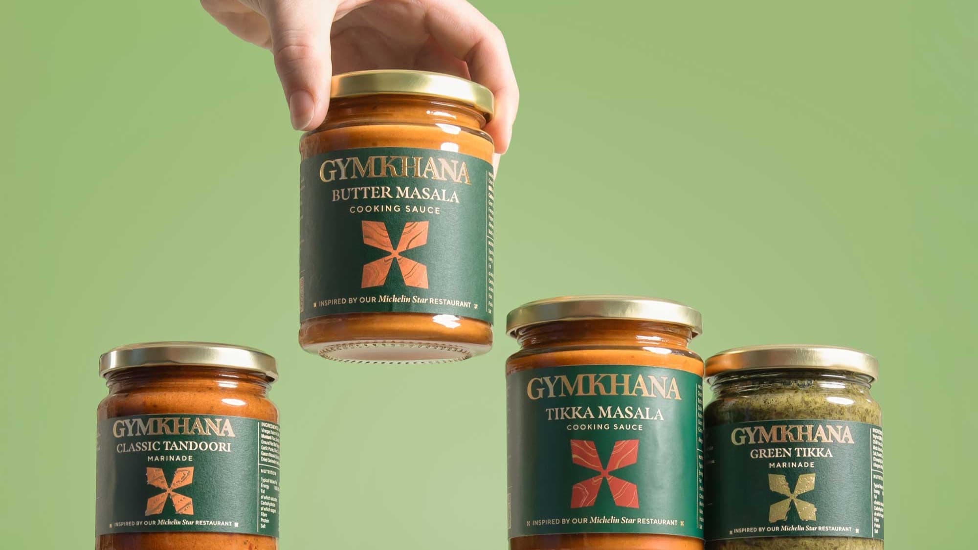 Gymkhana butter masala, tikka masala, and tandoori marinade jars on marble