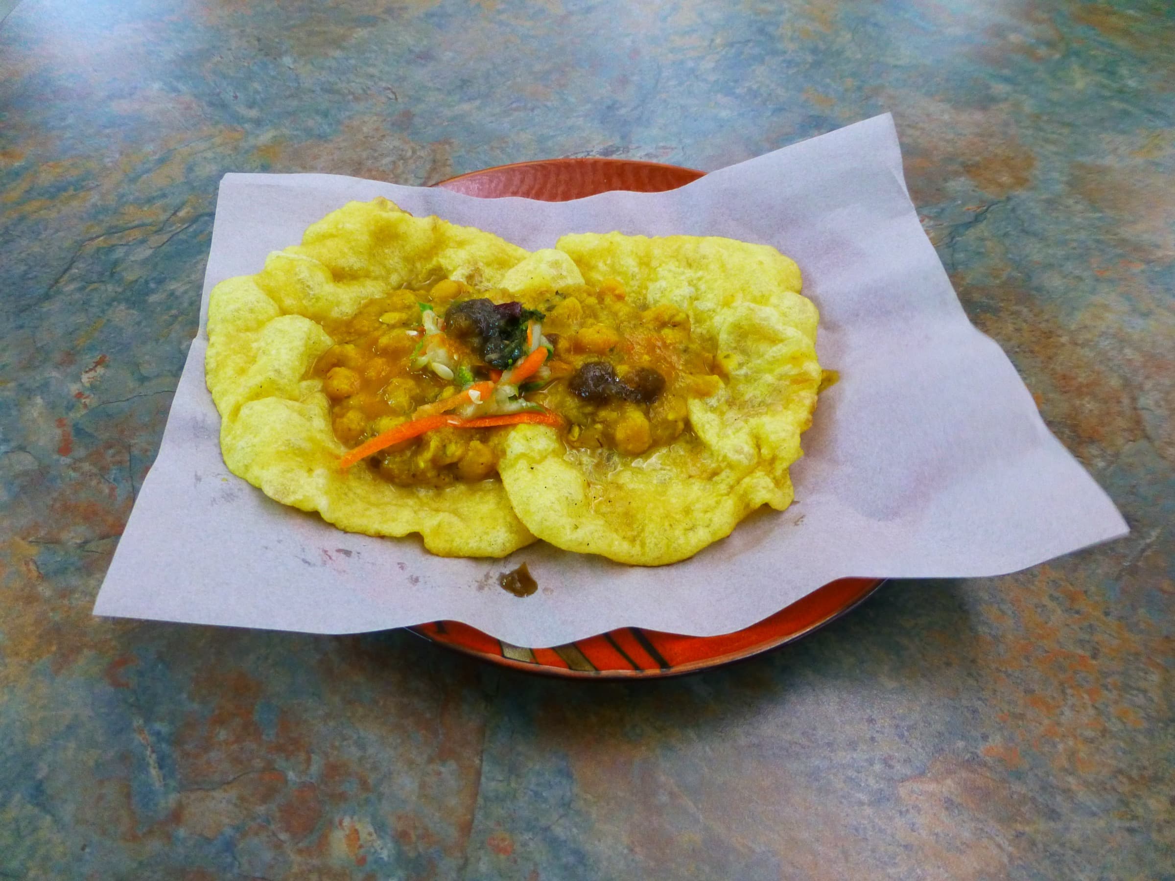 Trinidad doubles — curried chickpeas on two baras with chutney on paper
