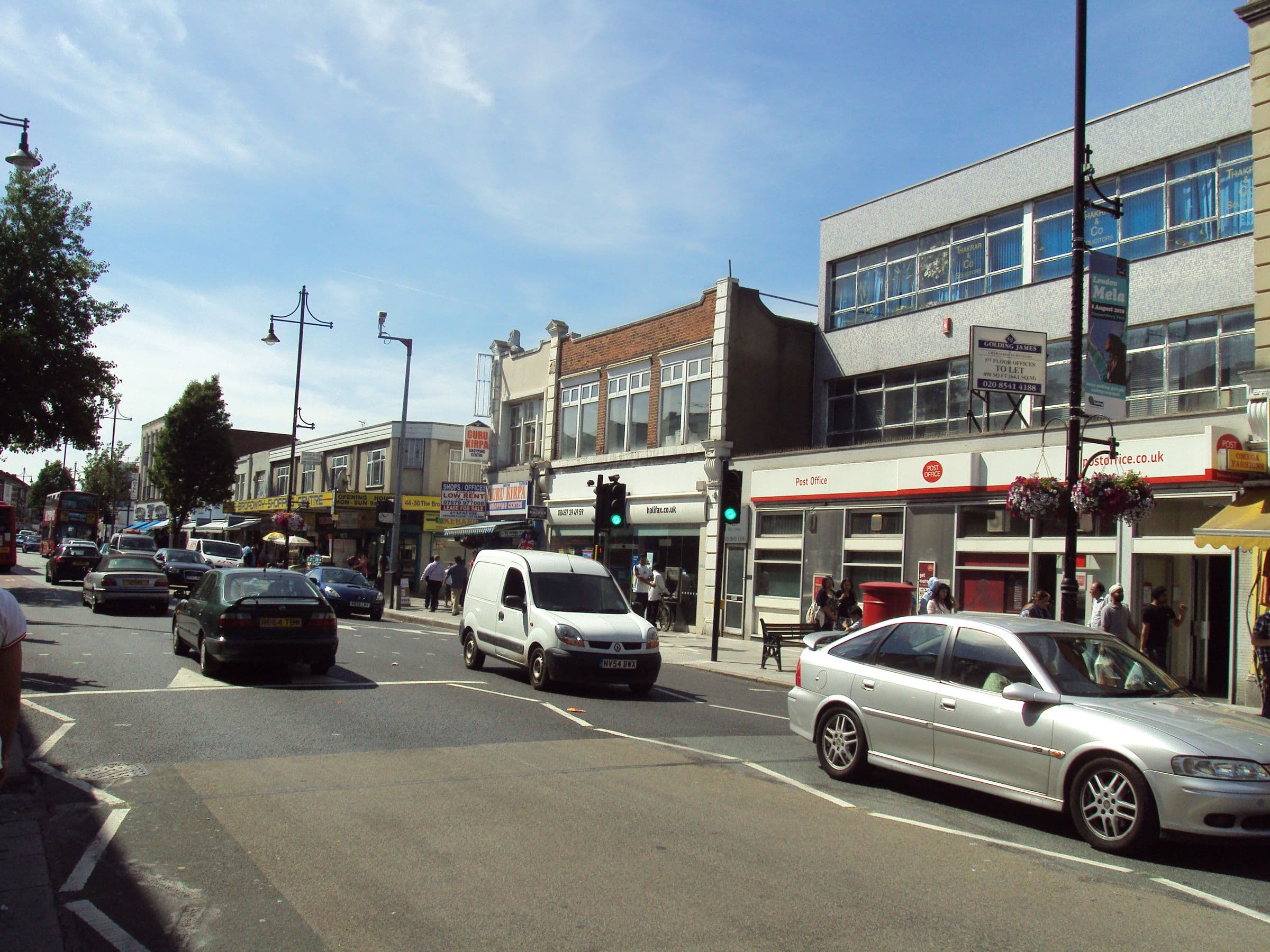 The Broadway in Southall, west London, with shops, traffic, and a London Mela banner
