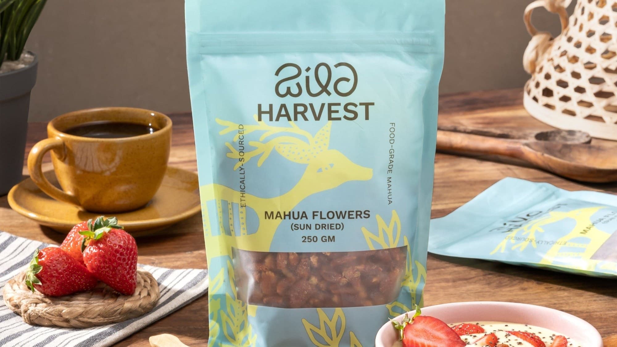 Wild Harvest sun-dried mahua flowers pouch beside a yogurt bowl topped with mahua and fruit
