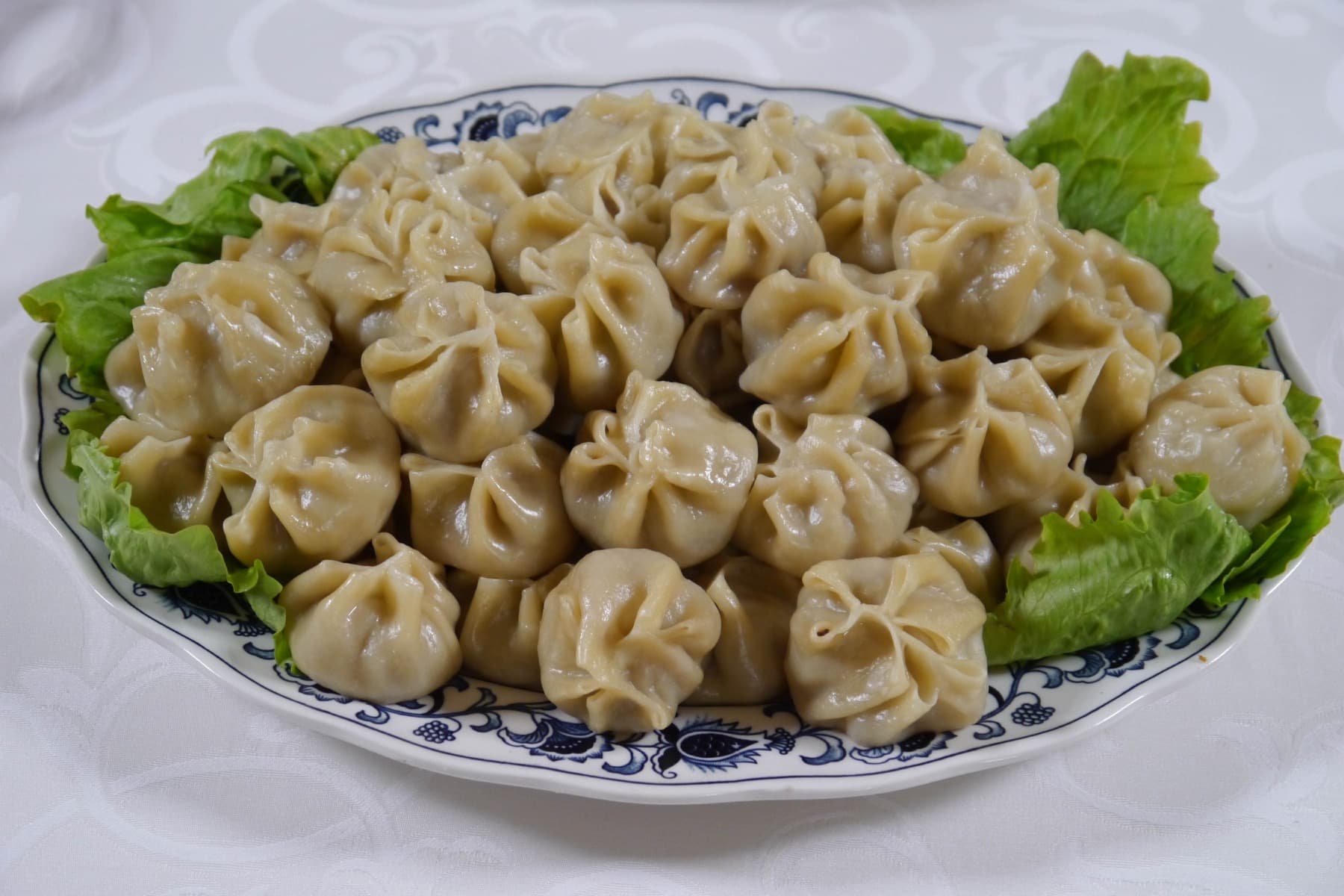 A platter of steamed Mongolian buuz dumplings with pleated tops