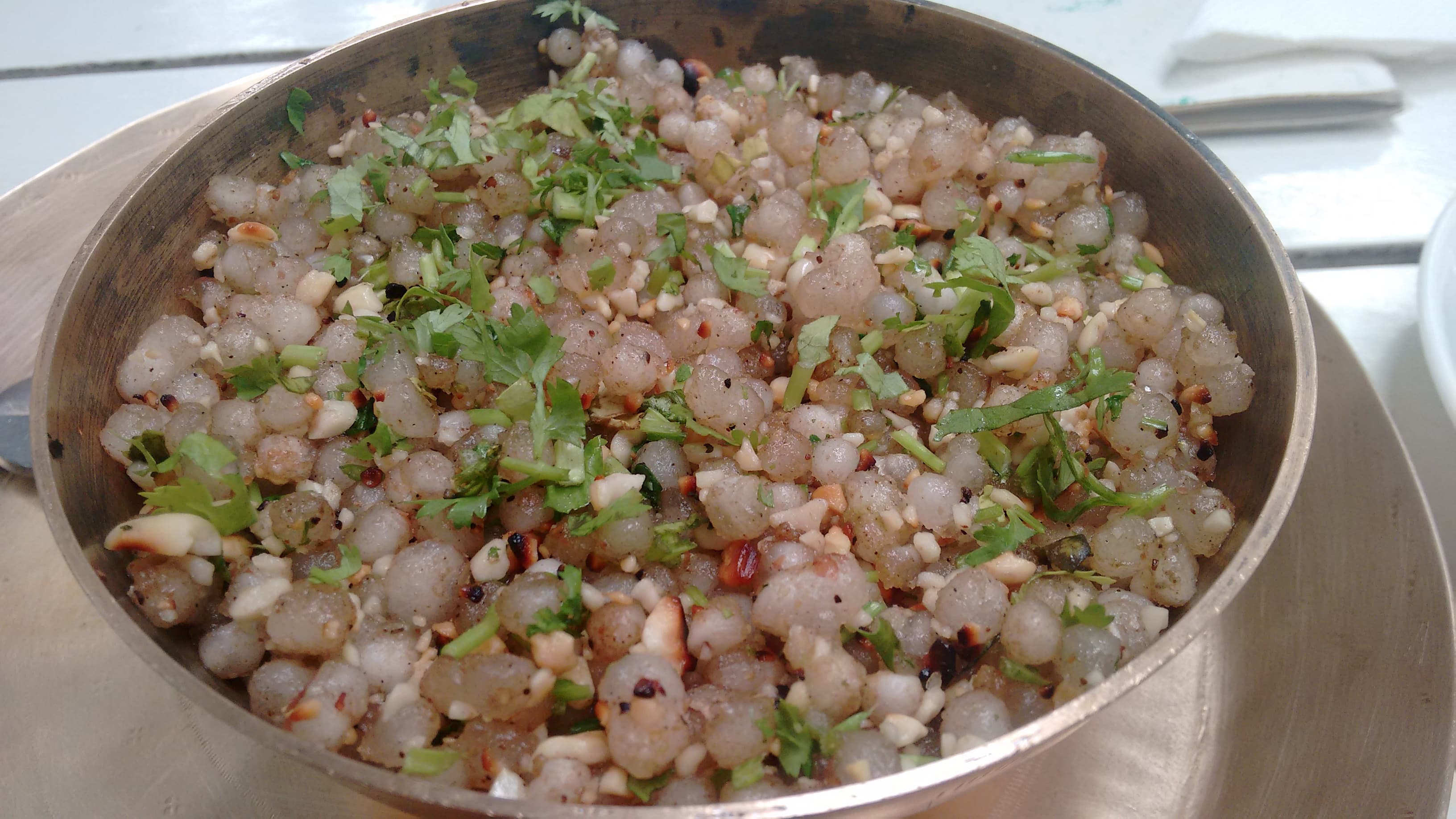 Sabudana khichdi with tapioca pearls, peanuts, potato, green chilli, and coriander